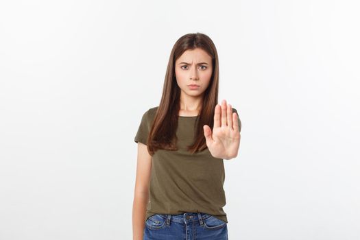 Portrait of young woman making stop sign in front of the camera