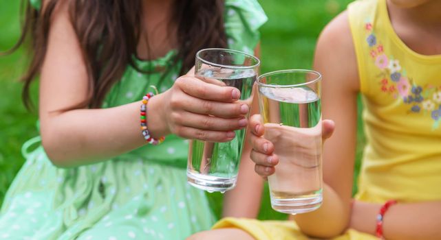 children drink clean water in nature.selective focus.nature