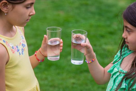 children drink clean water in nature.selective focus.nature