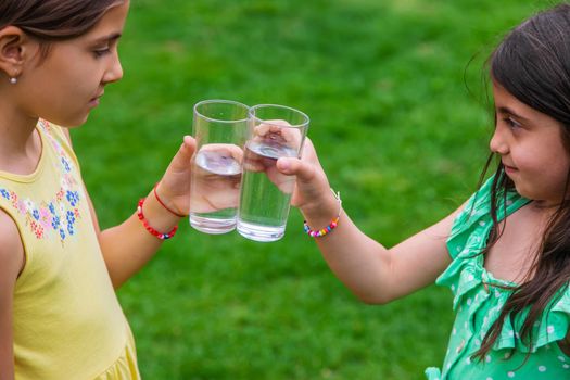 children drink clean water in nature.selective focus.nature