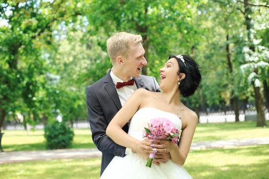 portrait of happy bride and groom on the background of nature