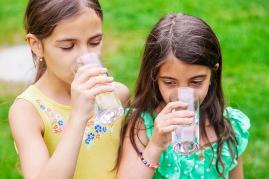 children drink clean water in nature.selective focus.nature