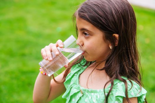 children drink clean water in nature.selective focus.nature