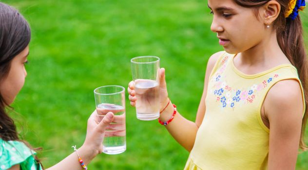 children drink clean water in nature.selective focus.nature