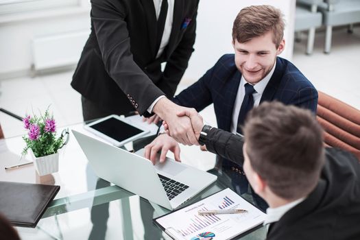 handshake Manager and the client after discussion of the financial contract in the workplace in the office.the photo has a empty space for your text