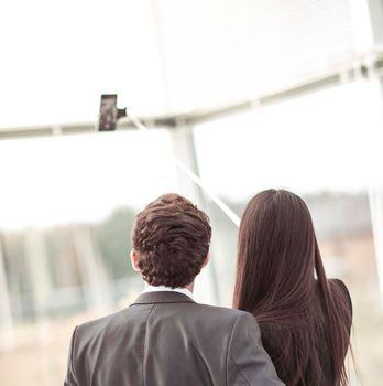 rear view of young company's employees make selfie in the lobby of the office