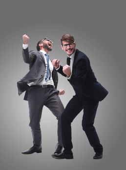 in full growth. two very happy young businessmen . isolated on white background.