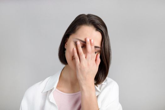 Human face expressions and emotions. Portrait of young brunette multiethnic face palm woman in pink tank and white shirt.