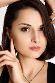 Mixed race young woman. Beautiful beauty portrait of gorgeous multiracial Caucasian multiethnic model with dark brown hair. Vertical headshot.