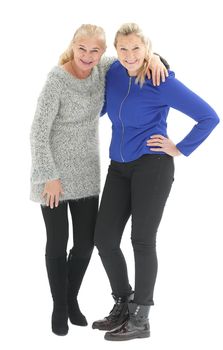 Two happy casual women smiling isolated over a white background