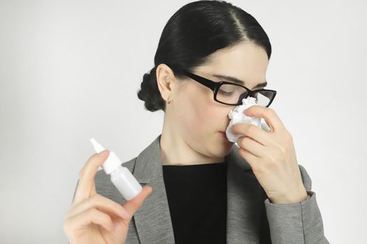 Treating a allergy with a nasal spray.