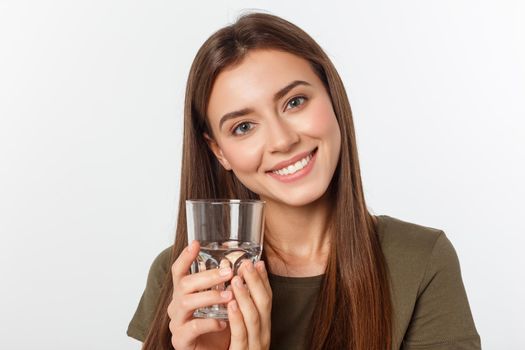 portrait of attractive caucasian smiling woman isolated on white studio shot drinking water