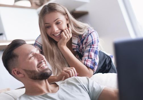 close up. young married couple looking at laptop screen