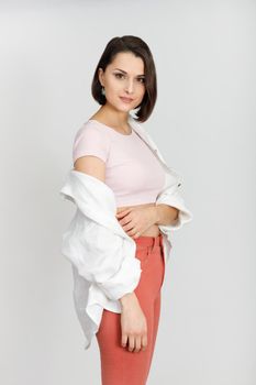 Young mixed race brunette woman studio portrait. Bright white colors. Beautiful woman looking at the camera. High-key headshot