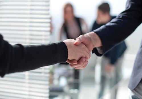 Business partnership meeting concept. Image businessmans handshake. Successful businessmen handshaking after good deal. Horizontal, blurred background