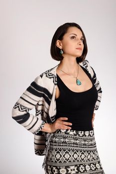 Vertical studio fashion portrait of young woman wearing indian style on white background.