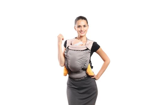 Babywearing attractive young mother with baby in carrier. Free hands and active motherhood concept.