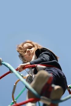 Cute little girl at the playground with copy space from above. Vertical, Selective soft focus