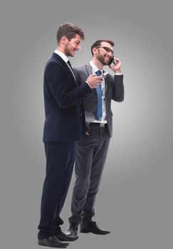 full length . two businessmen using their smartphones . isolated on white background