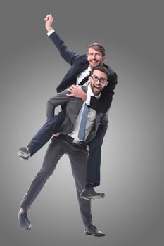 happy businessman carrying his colleague on the piggyback . isolated on white background