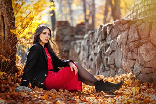 Young beautiful woman posing in autumn foliage outdoor.