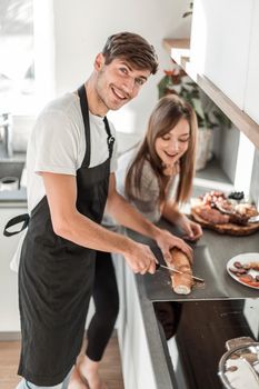 happy young couple standing in their new kitchen in the morning