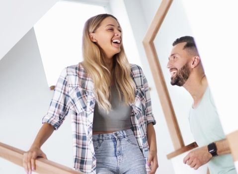 close up. happy couple on the stairs in their new apartment.