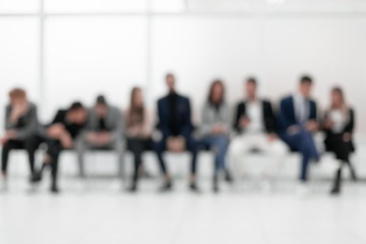 group of diverse young business people looking at their smartphone screens. photo with copy space