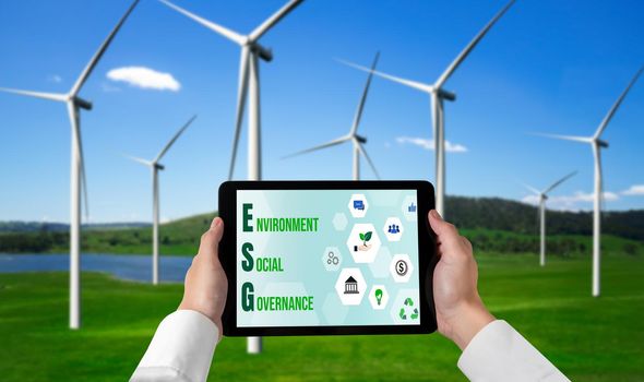 Green business transformation for environment saving and ESG business concept. Businessman using tablet to set corporate goal toward environmental friendly management and alternative clean energy use.