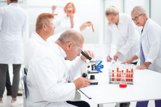 group of scientists conduct testing in the laboratory . concept of health protection.