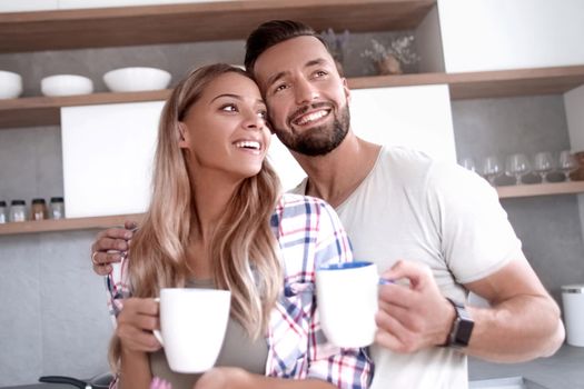 close up. young couple in love in the kitchen in a good morning