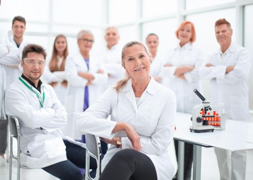 research supervisor and a group of young scientists in the workplace . photo with a copy-space.