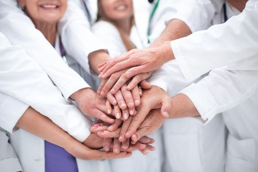 close up. large group of doctors put their hands together.