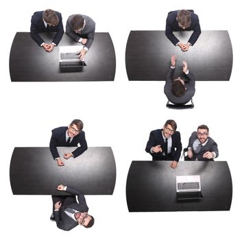 top view. two business people sitting at the Desk. isolated on white background