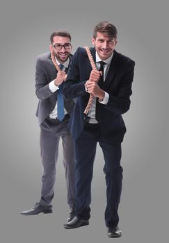 full length . two businessmen pulling a long rope. isolated on white background.