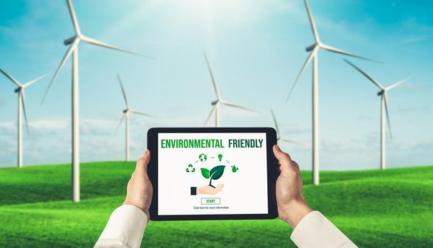 Green business transformation for environment saving and ESG business concept. Businessman using tablet to set corporate goal toward environmental friendly management and alternative clean energy use.