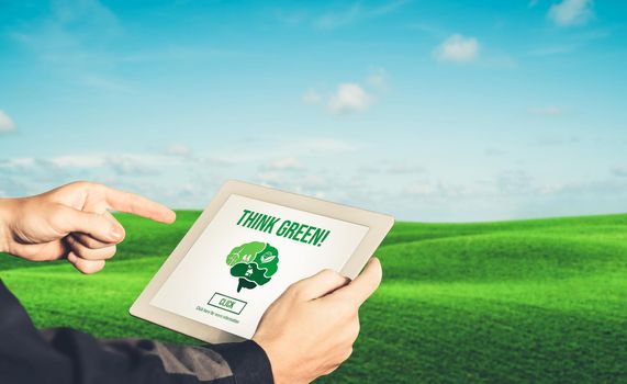 Green business transformation for environment saving and ESG business concept. Businessman using tablet to set corporate goal toward environmental friendly management and alternative clean energy use.