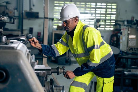 Factory worker or engineer do machine job in adept manufacturing workshop . Industrial people and manufacturing labor concept .