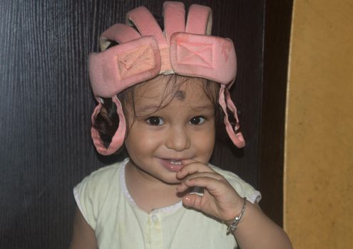 Cute Indian baby boy smiling and looking at camera.