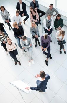 top view. listeners applauding the speaker at a business seminar. business and education