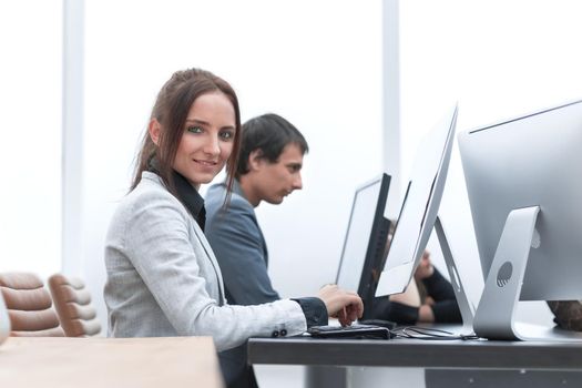 young woman is working on a computer in the office. business people