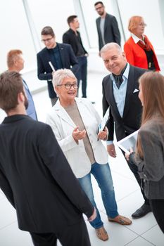 Top view business team conversation with documents in the office and handshake