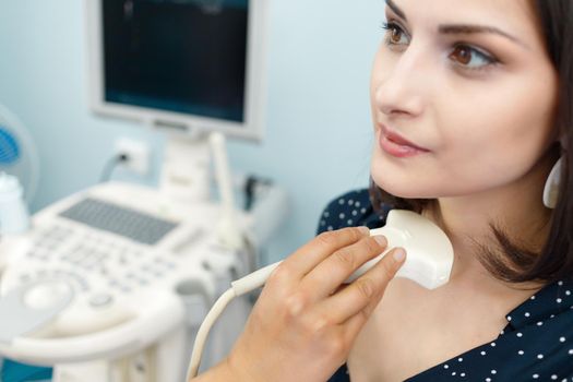 Close-up of ultrasound examination of the patient's neck region in the diagnostic clinic.