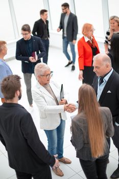 Top view business team conversation with documents in the office and handshake