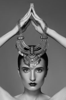Beautiful Woman with Silver Necklace in hand over head. Retro Indian Fashion Style. Jewelry Luxury Accessories. Black and White Photo