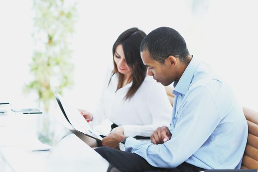 business colleagues discussing documents sitting at a Desk in the office.photo with copy space