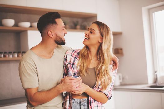 close up. happy young couple in kitchen in good morning time