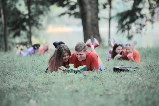 friends of students preparing for the exam, lying on the grass.