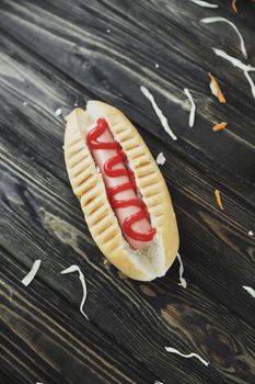 hotdog and cabbage slices on wooden background.photo with copy space.