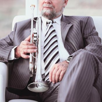 close up.adult male musician sitting in a chair.